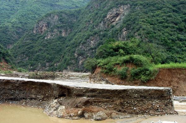 A destroyed road is seen in Chengxian County of Longnan City, northwest China's Gansu Province, Aug. 20, 2010. Landslides and mudslides occurred in the city due to the heavy rains from Aug. 11. Twenty-three people were reported killed.