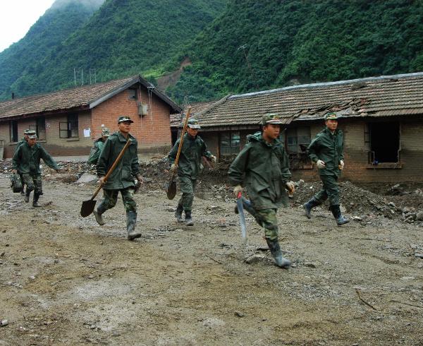 Soldiers rush to a rescue site in Huangzhu Township of Longnan City, northwest China's Gansu Province, Aug. 20, 2010. Landslides and mudslides occurred in the city due to heavy rains from Aug. 11. Twenty-three people were reported killed.
