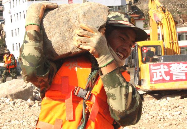 Photo taken on Aug. 20, 2010 shows Yan Yongping, a young soldier born in the 1990s, working on his duty in landslide-hit Zhouqu County, Gannan Tibetan Autonomous Prefecture in northwest China's Gansu Province, Aug. 23, 2010.