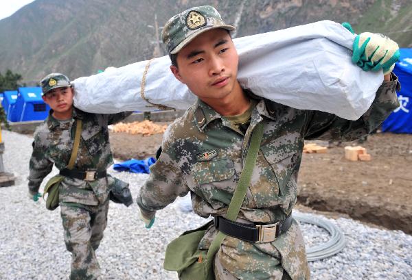 Xu Jiadong, a young soldier born in the 1990s, works on his duty in landslide-hit Zhouqu County, Gannan Tibetan Autonomous Prefecture in northwest China's Gansu Province, Aug. 23, 2010.