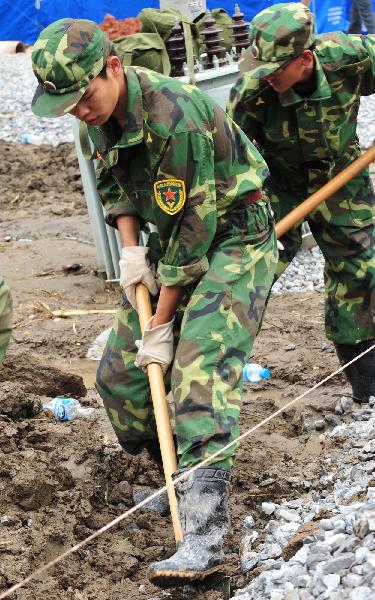 Zhou Kai, a young soldier born in 1990, works on his duty in landslide-hit Zhouqu County, Gannan Tibetan Autonomous Prefecture in northwest China's Gansu Province, Aug. 23, 2010.