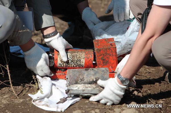 The black-box of a crashed passenger plane is found in Yichun City, northeast China's Heilongjiang Province, Aug. 25, 2010. A passenger plane with 96 people on board crashed late Tuesday night near the Yichun airport. At least 42 people were confirmed dead while the remaining 54 have been rescued and sent to hospitals. 