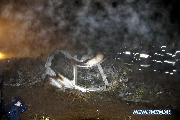 Rescuers search for bodies of victims beside the wreckage of a crashed passenger plane in Yichun City, northeast China&apos;s Heilongjiang Province, Aug. 25, 2010. 