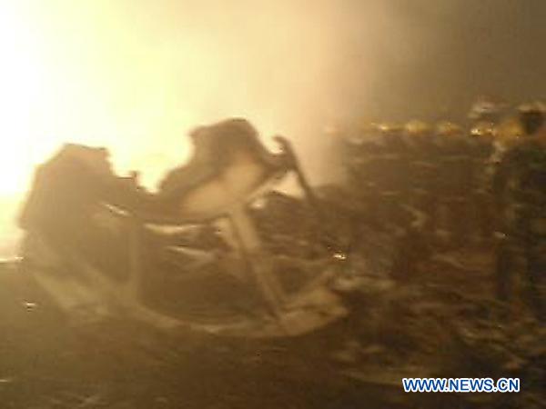 Rescuers and ambulances prepare for medical treatment of the injured near the site of the plane accident in Yichun, northeast China&apos;s Heilongjiang Province, Aug. 24, 2010.