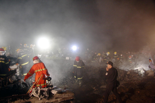 Rescuers work at the site of a reported plane crash at an airport in northeast China's Heilongjiang Province on Tuesday, August 24, 2010.