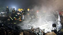 Rescuers work at the site of a reported plane crash at an airport in northeast China's Heilongjiang Province on Tuesday, August 24, 2010.