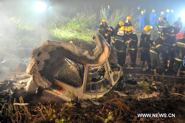 Rescuers search for survivors at the site where a passenger plane crashed in Yichun City, northeast China's Heilongjiang Province, early on Aug. 25, 2010. A passenger plane with 96 people on board crashed late Tuesday night the Yichun airport. At least 42 people were confirmed dead while the remaining 54 have been rescued and sent to hospitals. 