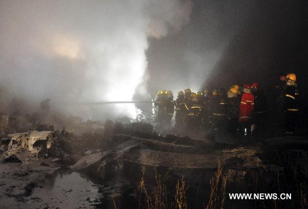 Rescuers search for survivors at the site where a passenger plane crashed in Yichun City, northeast China's Heilongjiang Province, Aug. 24, 2010. 