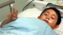 A wounded boy reacts to the reporter at the First Affliated Hospital of Harbin Medical University in Harbin, capital of northeast China's Heilongjiang Province, Aug. 25, 2010.