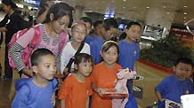 Children from Zhouqu arrive in Beijing, Aug. 26, 2010.