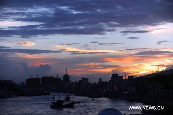 Crimson clouds at sunset are seen in a harbour of Zhoushan City, east China's Zhejiang Province, Aug. 31, 2010. 