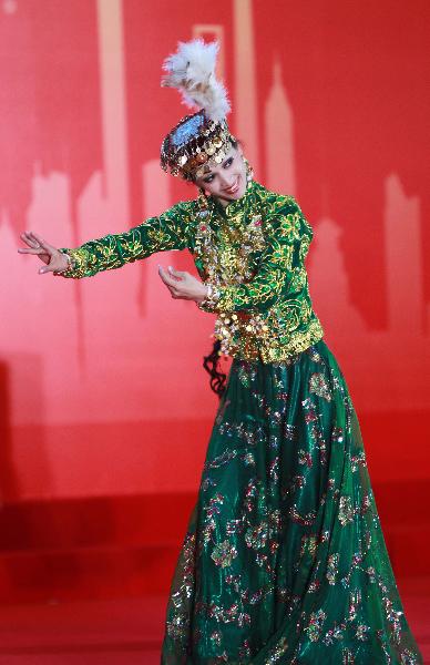 A dancer performs during a ceremony marking the National Pavilion Day for Uzbekistan at the 2010 World Expo in Shanghai, east China, Aug. 31, 2010. 