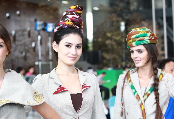Models pose for photos during a ceremony marking the National Pavilion Day for Uzbekistan at the 2010 World Expo in Shanghai, east China, Aug. 31, 2010.