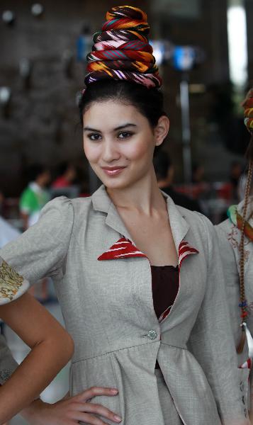 A model poses for photos during a ceremony marking the National Pavilion Day for Uzbekistan at the 2010 World Expo in Shanghai, east China, Aug. 31, 2010.