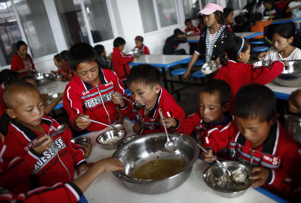 Orphaned boyss eat in the dining hall at a charity school in Liangshan Yi Autonomous Prefecture, southwest China&apos;s Sichuan Province August 27, 2010.