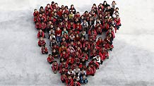 Orphaned students sit as the shape of a heart for photos at a charity school in Liangshan Yi Autonomous Prefecture, southwest China's Sichuan Province August 27, 2010.