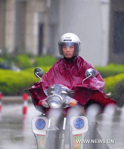 A motorist is seen in rain in Fuqing City of southeast China&apos;s Fujian Province, Aug. 31, 2010. 