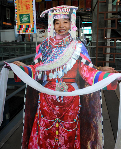 A visitor poses in traditional Tibetan costumes on Sept 3.