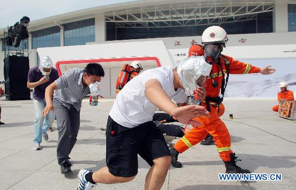 Firefighters disperse civilians in an anti-terror drill at Tianjin Meijiang Convention and Exhibition Center in Tianjin, east China, Sept. 8, 2010, as a part of preparation for the 2010 Summer Davos Forum which will kick off Sept. 13.