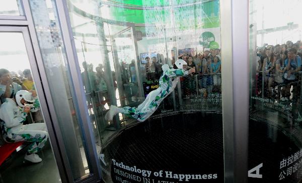 A Latvian acrobat performs in a wind tunnel which blows off winds of 200 kilometers per hour from the bottom, in the Latvia Pavilion in the Shanghai World Expo Park in Shanghai, east China, Sept. 8, 2010.