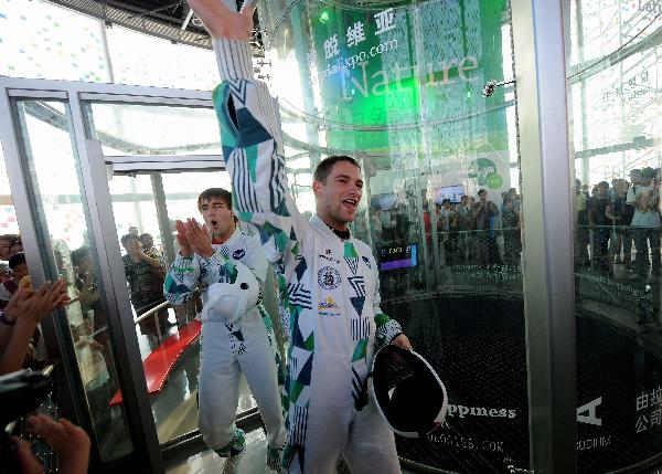 Two Latvian acrobats perform in a wind tunnel which blows off winds of 200 kilometers per hour from the bottom, in the Latvia Pavilion in the Shanghai World Expo Park in Shanghai, east China, Sept. 8, 2010. 