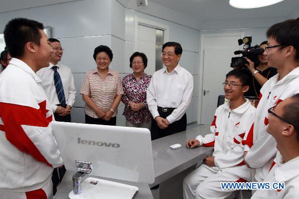 Chinese President Hu Jintao talks with students in the affiliated high school of Renmin University of China in Beijing, Sept. 9, 2010. 