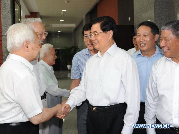 Chinese President Hu Jintao shakes hands with a senior teacher in the Renmin University of China in Beijing, Sept. 9, 2010. 