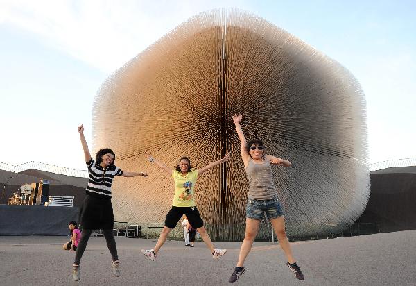 Visitors have photos taken outside the Seed Cathedral, the pavilion of the United Kingdom, at the Expo Park in east China's Shanghai Sept. 9, 2010.