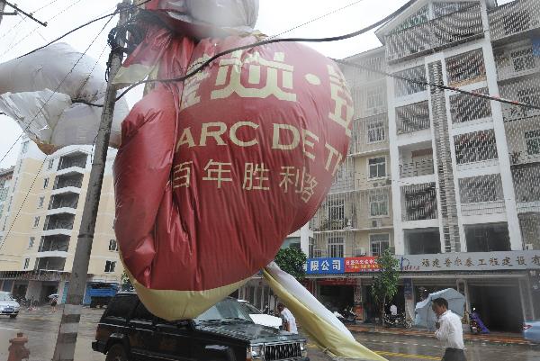 The photo taken on Sept. 10, 2010 shows an advertisement torn down by the typhoon Meranti in downtown Putian, southeast China's Fujian Province, Sept. 10, 2010.
