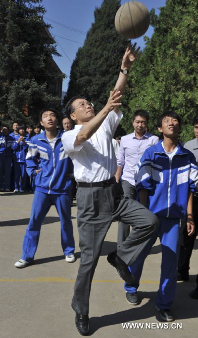 Chinese Premier Wen Jiabao plays basketball with students at a middle school in Xinglong County, north China's Hebei Province on Sept. 10, 2010. 