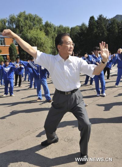 Chinese Premier Wen Jiabao practices Taiji boxing with students at a middle school in Xinglong County, north China's Hebei Province on Sept. 10, 2010. 