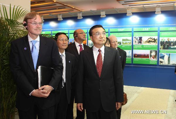 Chinese Vice Premier Li Keqiang (R, front) and World Bank President Robert Zoellick (L, front) visit an exhibition before the opening ceremony of the Conference ot the 30th Anniversary of China-World Bank Cooperation in Beijing, Sept. 13, 2010.