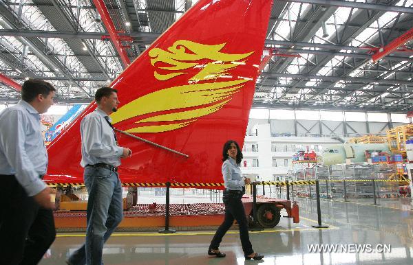 Participants of the Annual Meeting of the New Champions 2010, visit the Airbus A320 Final Assembly Line in Tianjin during a industry tour as a program of the World Economic Forum (WEF) Annual Meeting of the New Champions 2010, in north China's Tianjin Municipality on Sept. 14, 2010. 