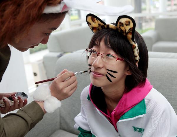 A student gets face painted to act as an animal to call for animal protection during a summit at Beijing 101 Middle School in Beijing, capital of China, on Sept. 18, 2010.