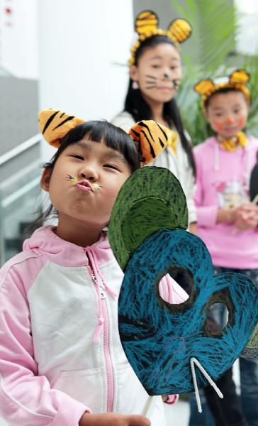 Students get dressed like animals to call for animal protection during a summit at Beijing 101 Middle School in Beijing, capital of China, on Sept. 18, 2010.