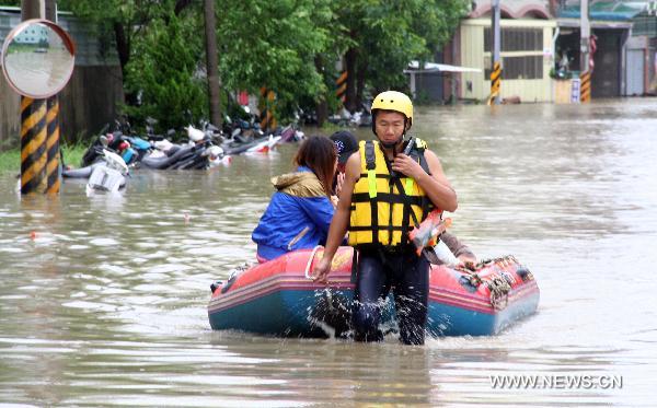 Rescuers transport trapped residents with light boat in Tainan County, south China's Taiwan, Sept. 20, 2010. 