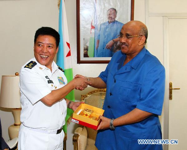 Deputy Commander of the Chinese Navy Lieutenant General Xu Hongmeng (L) offers a gift to Dileita Mohamed Dileita, prime minister of Djibouti, in Djibouti, Sept. 22, 2010. The ship arrived in Djibouti on Wednesday to provide seven-day medical treatment for locals.