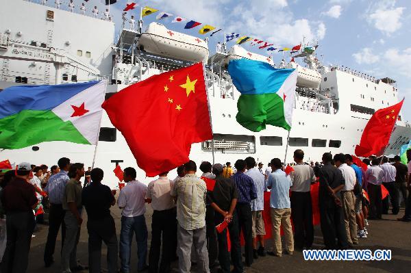 Overseas Chinese delegates welcome the arrival of the Chinese navy hospital ship &apos;Peace Ark&apos; in Djibouti, Sept. 22, 2010. The ship arrived in Djibouti on Wednesday to provide seven-day medical treatment for locals.