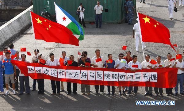Overseas Chinese delegates welcome the arrival of the Chinese navy hospital ship &apos;Peace Ark&apos; in Djibouti, Sept. 22, 2010. The ship arrived in Djibouti on Wednesday to provide seven-day medical treatment for locals.