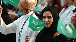A woman waves the national flag of Saudi Arabia at a ceremony marking the National Pavilion Day for Saudi Arabia at the 2010 World Expo in Shanghai, east China, Sept. 23, 2010.