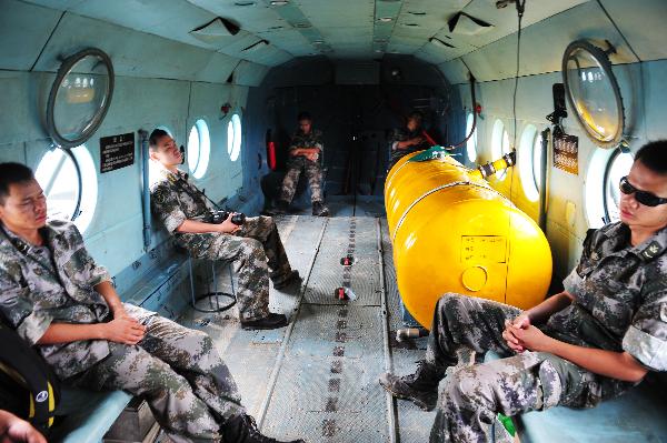 Soldiers take a nap on their way back from conducting an air-drop duty in Xinyi, south China&apos;s Guangdong Province, Sept. 25, 2010. Since torrential rainstorm brought by Typhoon Fanabi hit Guangdong this week and caused serious waterlog, China&apos;s army aviation regiment has bridged an air lifeline by airdropping daily necessities to disaster-stricken people.