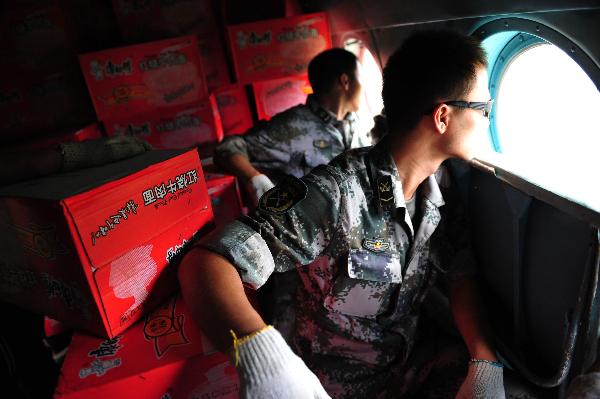 Soldiers prepare to air-drop food supply as the military helicopter approaches a drop-off point in Pingtang village of Xinyi, south China&apos;s Guangdong Province, Sept. 25, 2010. Since torrential rainstorm brought by Typhoon Fanabi hit Guangdong this week and caused serious waterlog, China&apos;s army aviation regiment has bridged an air lifeline by airdropping daily necessities to disaster-stricken people. 