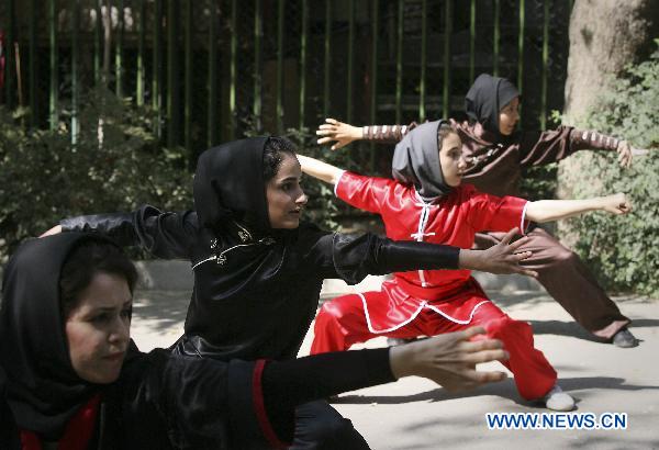 Iranian girls perform Chinese martial arts in a park in Tehran, capital of Iran, on Sept. 24.