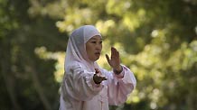 Qiu Xueqin, the director of the Confucius Institute at Tehran University, plays Taiji in a park in Tehran, capital of Iran, on Sept. 24.