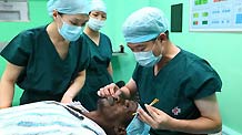 Chinese medical workers prepares to perform a cataract surgery for a 53-year-old Djibouti man aboard the Chinese navy hospital ship 'Peace Ark' in Djibouti Sept. 25, 2010.