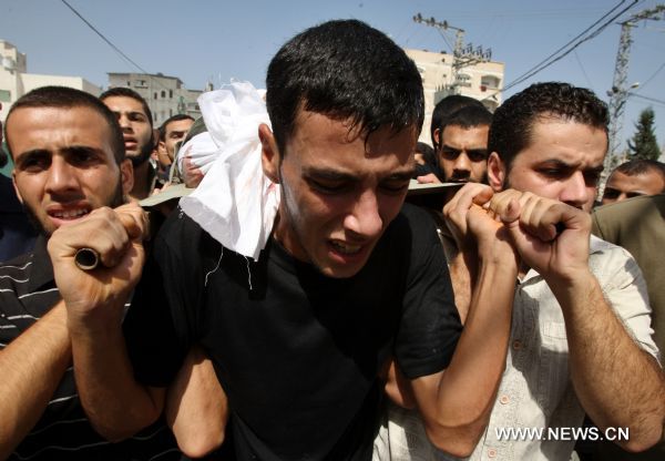 Palestinian mourners carry the body of Islamic Jihad militant Awni Abdelhadi, who was killed by Israeli shelling, during his funeral in the al-Bureij refugee camp, central Gaza Strip, Sept. 28, 2010. 