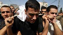 Palestinian mourners carry the body of Islamic Jihad militant Awni Abdelhadi, who was killed by Israeli shelling, during his funeral in the al-Bureij refugee camp, central Gaza Strip, Sept. 28, 2010.