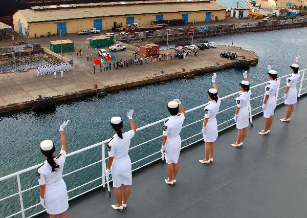 Crew members of China's hospital ship Peace Ark waves goodbye on the deck as the ship leaves the port of Djibouti, Sept. 29, 2010. 