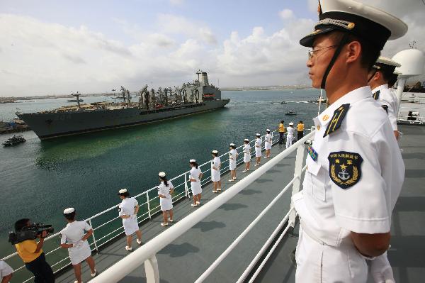 Crew members of China's hospital ship Peace Ark stand on the deck as the ship leaves the port of Djibouti, Sept. 29, 2010. 