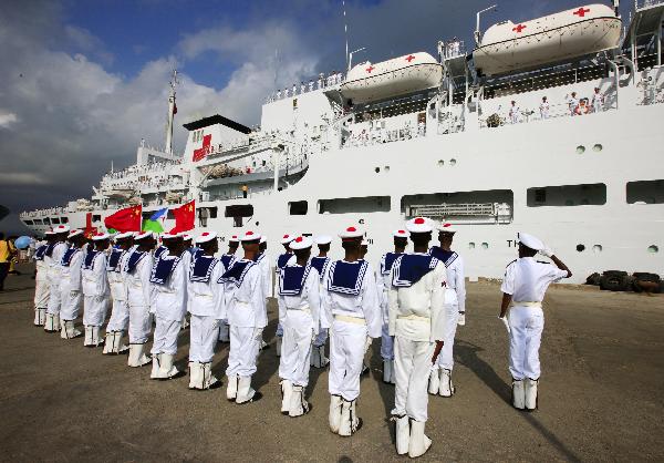Djibouti navy soldiers salute in front of China's hospital ship Peace Ark at the port of Djibouti, Sept. 29, 2010.